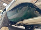 a close up of a car under a vehicle in a garage