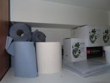several rolls of toilet paper are on a shelf in a bathroom