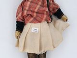 an image of a doll with a hat and a skirt