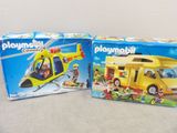 two boxes of playmobil toys on a table