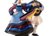 a figurine of a man and a woman holding a guitar