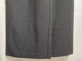 a black skirt hanging on a white curtain in a room