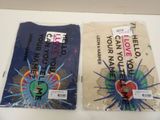 two t - shirts that are sitting on a table