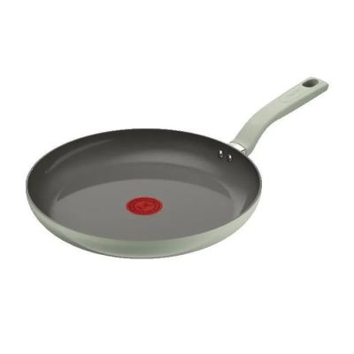une poêle sur fond blanc avec un point rouge