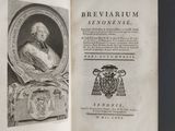 an open book with a picture of a man sitting in a chair on top of a table