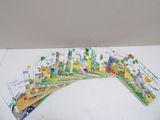 several children ' s books are lined up on a white surface