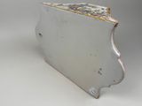 a white box with gold trim on it on a white surface