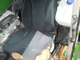 a seat in the back of a truck with a bottle of water on it