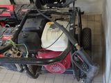 a picture of a small lawn mower with a hose attached to it