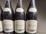 six bottles of red wine are lined up in a row