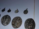 a lot of silver coins on display on a table