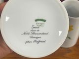 a person holding a white plate with a picture on it