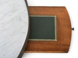a mirror with a wooden frame and a green mat on it
