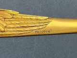 a gold horn with wings on it on a table