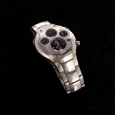 a close up of a watch on a black surface
