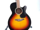 an acoustic guitar sitting on top of a stand on a white surface