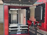 a red and black food truck with a pizza oven