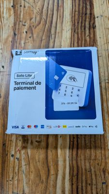 the box is open on a wooden table with a remote control in it