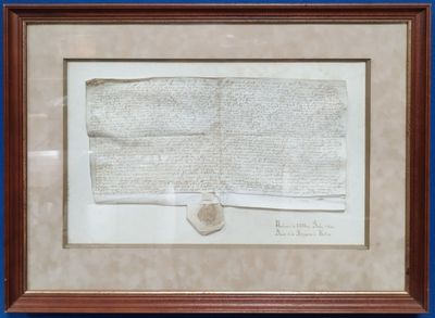 un vieux bout de papier avec des inscriptions, encadré