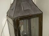 a small lantern sitting on top of a white shelf