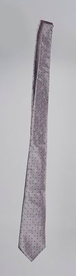 a tie hanging from the side of a pole in the air