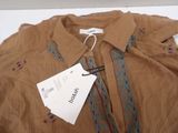 a brown shirt with a tag on it on a table