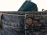 pocket of a pair of blue jeans with a zipper on the back