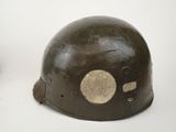 an old helmet with a hole in the middle of it