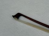 a violin bow that is laying on a white surface