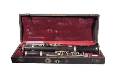 a black and silver clarinet in a case on a white background