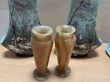 three vases sitting on a table next to each other