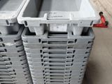 many plastic containers stacked on top of a pallet
