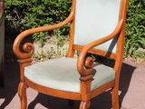 two chairs that are sitting next to each other on the sidewalk