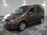 the brown van is parked on a checkered floor in the garage