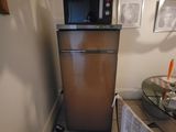 an image of a small kitchen with a microwave and a table