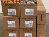 several boxes of garnier are stacked on a pallet in a warehouse