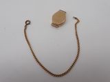a close up of a gold chain with a locke on it