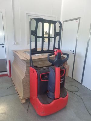a red forklift truck parked in a garage