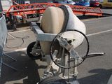a cement mixer sitting on the side of the road