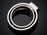 a close up of a silver ring on a black surface