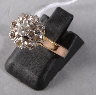 a close up of a gold ring with a flower design on it