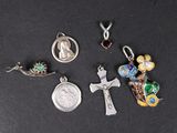 a close up of a group of religious charms on a black surface