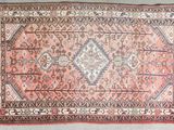 an old persian rug with a diamond design on it