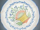 a white plate with a blue and yellow design on it