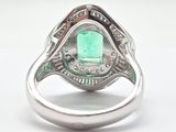 an image of a ring with a green stone in the center