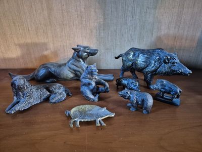 many figurines of animals on a wooden table