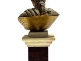 statue of a boy sitting on a bowl with a bird on top of it