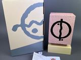 pink and blue box with a logo on it next to a business card