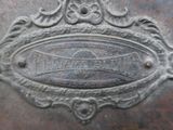 a close up of a metal plate with a name on it