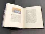an open book on a table with a stamp on it